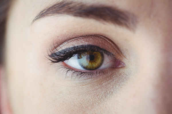 Green eye showing a permanent eyeliner