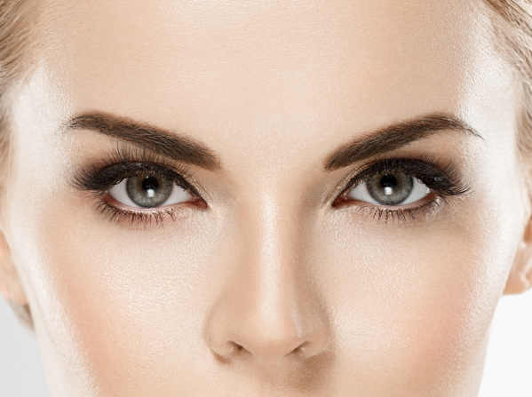 A beautiful woman showing perfect and shinny eyebrows after an eyebrow lamination
